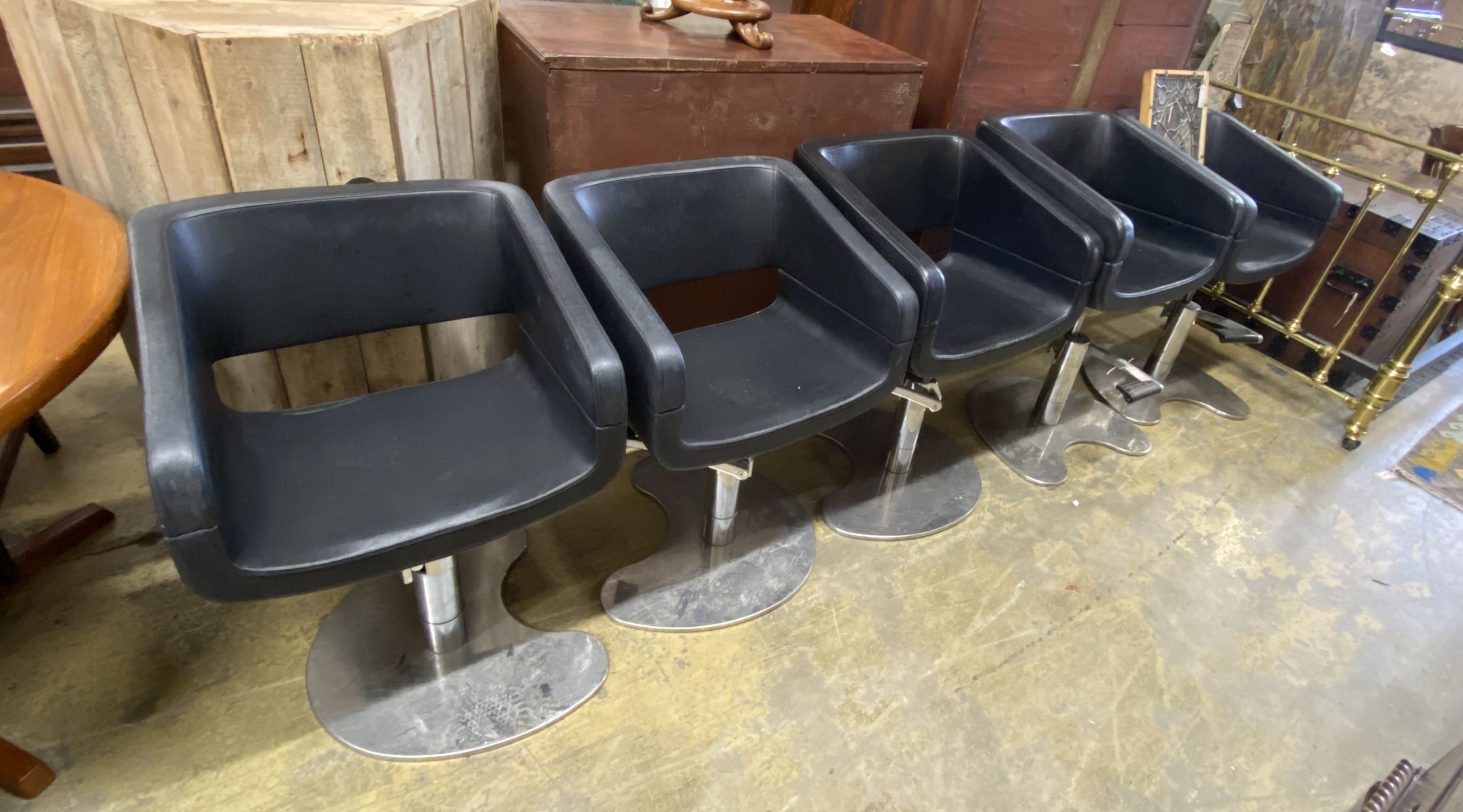 A set of five REM black leatherette and chrome hydraulic salon chairs, width 56cm, depth 42cm